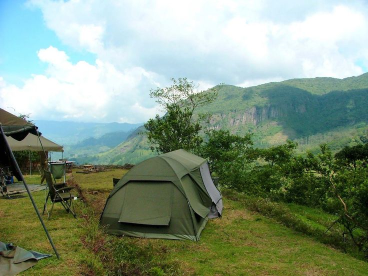 Wilderness tent camping under a misty mountain ridge in Riverston