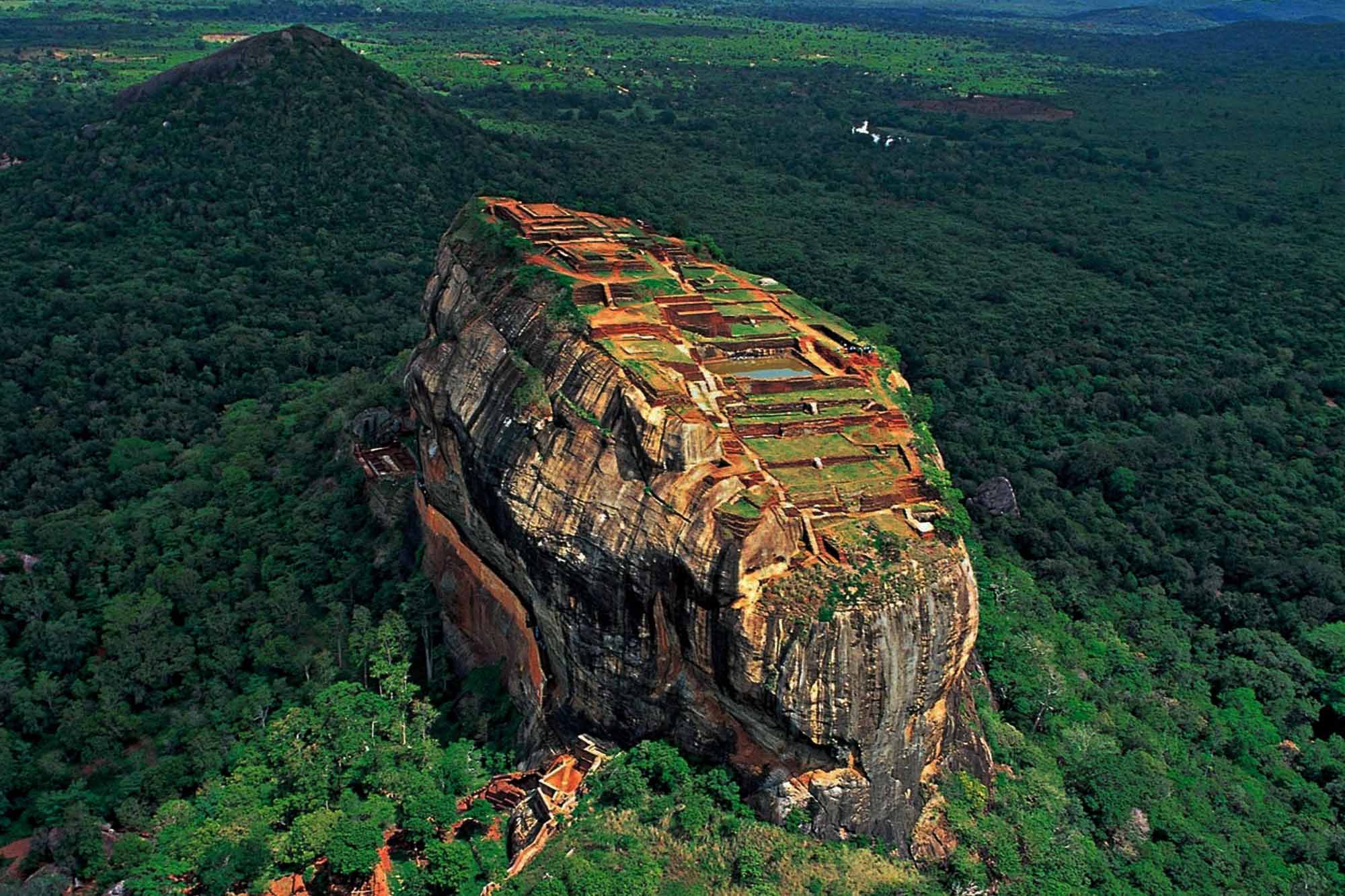 Sigiriya Lion Rock fortress rising above green forest